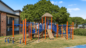 A playground with a slide, swings, and a climbing frame.